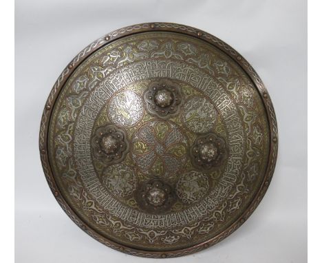 Islamic Mumlok revival cast brass shield having inlaid silver and Arabic calligraphy decoration, diameter 58cm