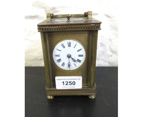 Small late 19th / early 20th Century gilt brass carriage clock, the circular enamel dial (at fault) with Roman numerals, the 