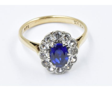 9ct Gold dress ring set oval blue sapphire surrounded by white sapphires, size K, 2.2gThe ring head overall is 12 x 10mm and 