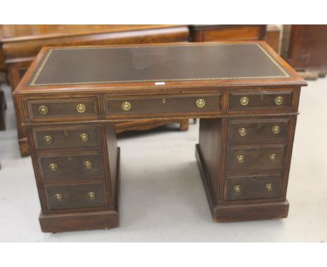 Edwardian mahogany twin pedestal desk, the leather inset top above nine drawers with brass ring handles and plinth bases, 122