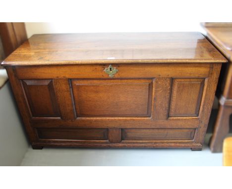 Oak coffer, the hinged lid above a fielded five panel front on stile supports, 127cm wide x 54cm deep x 71cm high