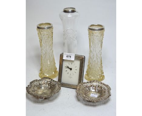 Pair of circular silver bonbon dishes, three silver mounted glass specimen vases, and a small silver mounted table clock