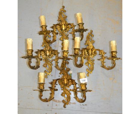 Set of four mid 20th Century gilt brass twin light wall sconces
