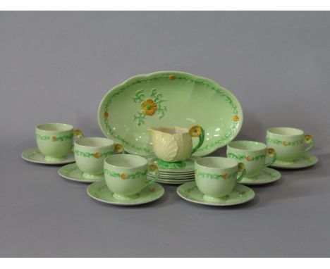 A collection of Carltonware Buttercup pattern teawares with moulded floral handles comprising oval serving dish, six cups, si