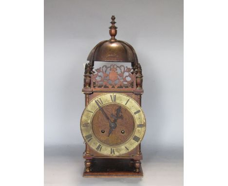 19th century twin train lantern clock with silvered chapter ring engraved with Roman numerals in a typical case with pierced 