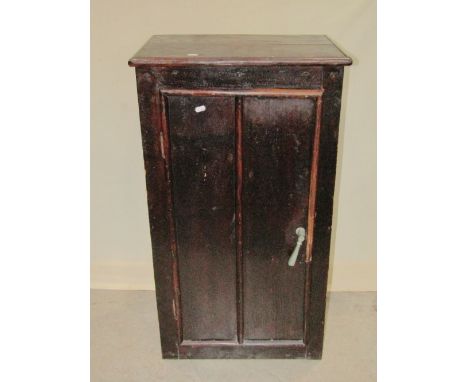 A rustic stained pine side cupboard of tongue and groove boarded construction, enclosed by a single door, with shelved interi