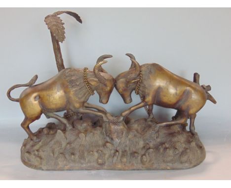 Probably Eastern cast bronze character group of butting rams under a palm tree on a naturalistic oval base, unsigned, 52 cm l