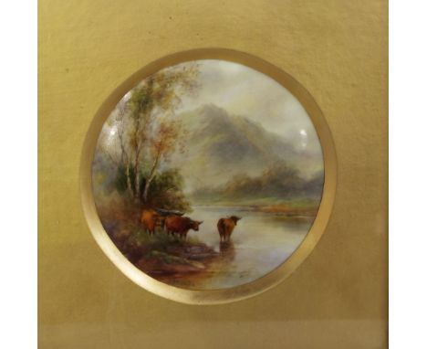 A Royal Worcester plaque of circular form with painted decoration by James Stinton showing highland cattle watering in a moun
