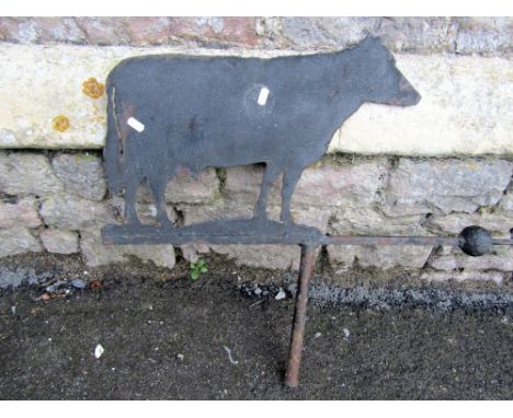 An iron work weather vane, the cut sheet steel metal finial in the form of a cow, 60 cm in height approx, together with a cas