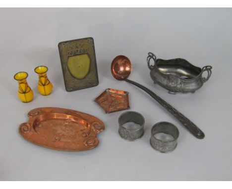 A box containing a collection of mainly arts and crafts metal wares to include two copper pin trays, a copper and iron ladle,