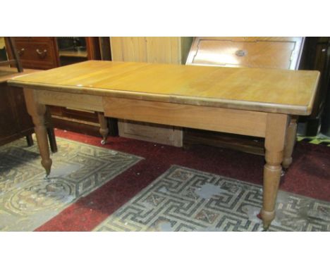 A good quality Victorian style light oak pull out extending dining table of rectangular form, with moulded outline and single