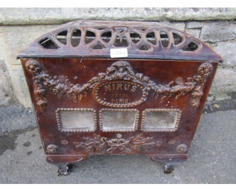 A French cast iron and brown treacle glazed enamel stove of rectangular form, with pierced cover and decorative tied ribbon a
