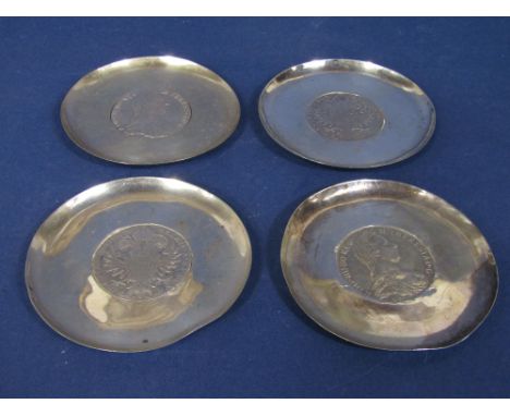 Four continental white metal trinket dishes, each inset with an Austrian Thaler, 7oz approx (4)