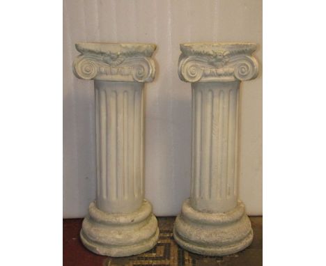 A pair of plaster pedestals in the form of architectural cylindrical reeded columns with doric capitals, 74 cm high