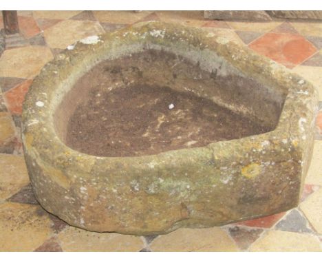 A small unusual natural stone horseshoe shaped trough, with single squared off end, 55cm x 50cm approx; together with a buff 