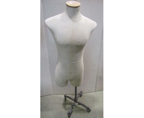 A vintage tailors/shop display mannequin labelled Aubin &amp; Wills raised on a cast alloy stand with castors