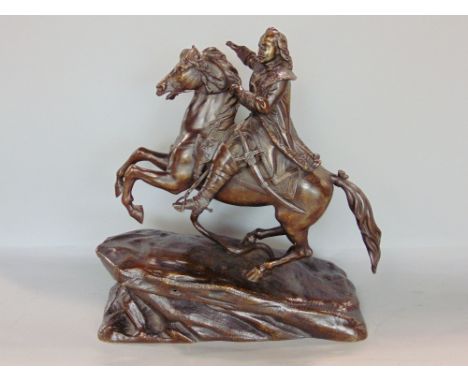 Cast bronze character group of a cavalier type gentleman on horseback with a snake at their feet, upon a naturalistic type ba
