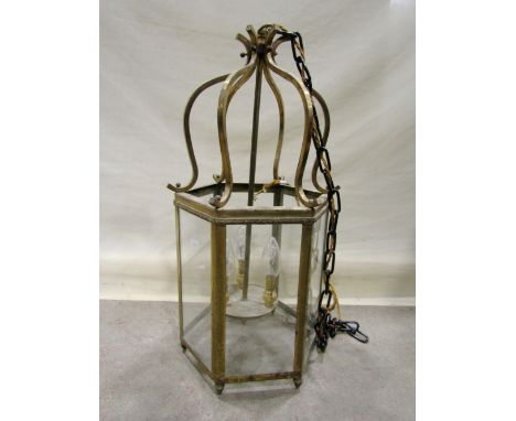 A Georgian style hall/porch lantern of hexagonal form with glazed panels enclosing a four candle bulb electric light