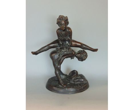 Cast bronze character group of two boys playing leap frog, 25cm high