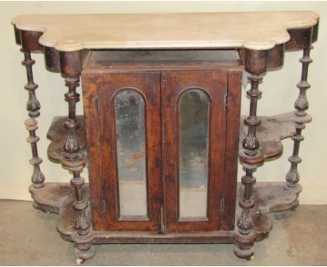 A Victorian walnut side cabinet enclosed by a pair of slender arched mirror panelled doors, flanked by open shelves, beneath 