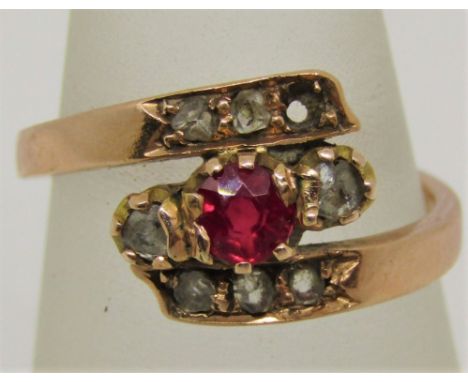 Russian 14ct ruby and diamond crossover ring, outer shank stamped '56' with further indistinct marks, size J/K, 2.6g (one dia