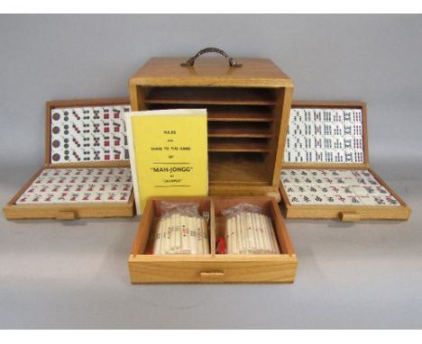 Complete cased Mahjong set, the case with open dovetail joints enclosing five long graduated drawers upon bun feet, 20cm high