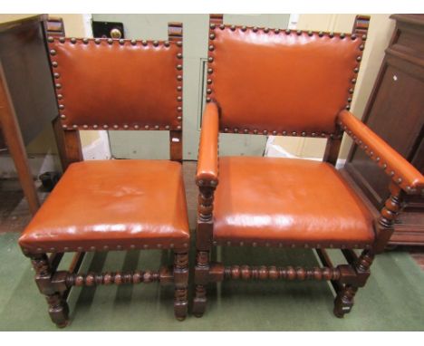 A set of ten (8+2) oak dining chairs in the Cromwelian style, with light tan leather upholstered seats and backs with brass s
