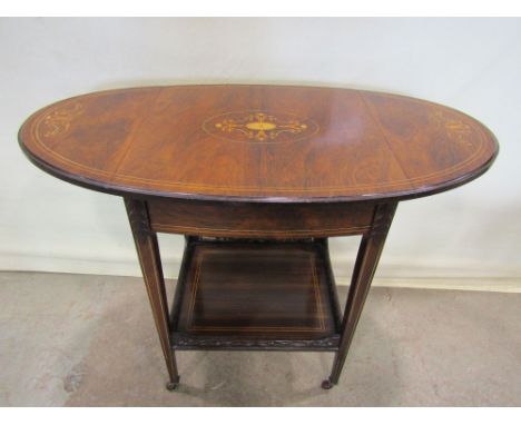 A small Edwardian rosewood drop leaf occasional table, the top of oval form when extended, over a frieze drawer raised on fou