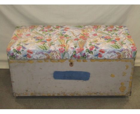 A vintage painted pine trunk with upholstered hinged lid and flush fitting carrying handles with painted finish
