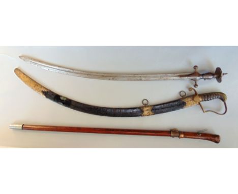 Two interesting cutlass type swords, one with leather sheath and handle with worked brass hand guard, the other an eastern Sh