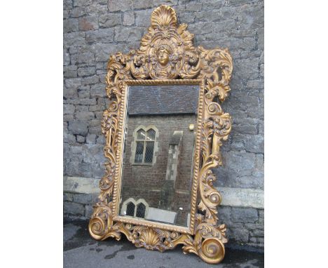 A large and impressive contemporary reproduction wall mirror with rectangular bevelled edge plate within a light composite fr
