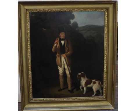 Early 19th century British school, full length portrait of a sportsman holding a gun, accompanied by his spaniel in a wooded 