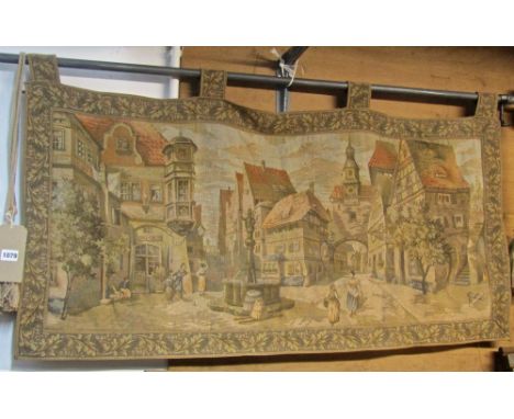 A machine woven Belgian cotton tapestry wall hanging showing a pictorial town scene within an acanthus border, 116 cm long x 