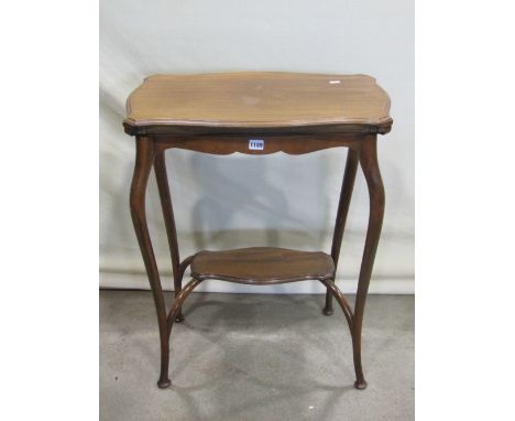 An Edwardian mahogany and stained beechwood foldover top card table with serpentine moulded outline, raised on shaped legs un