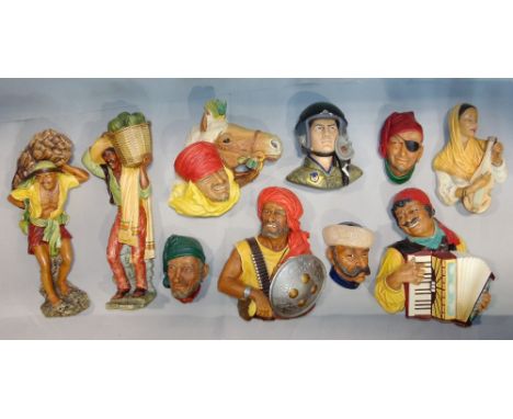 A collection of ten Bossons wall plaster plaques, two full length plaques of gentlemen carriers, together with an accordion p