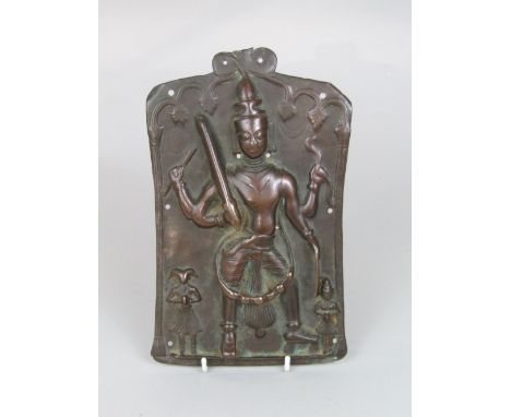 Interesting embossed eastern bronze panel with a standing Buddhistic deity flanked by an attendant and ram headed attendant, 