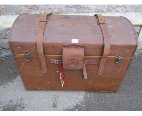 A vintage brown fibre and stitched leather reinforced domed top travelling trunk, with brass lock, triangular stork badge and