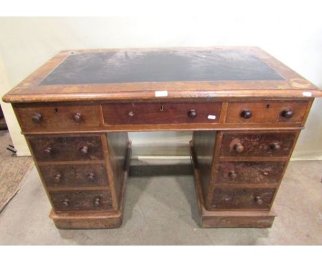 A small Victorian mahogany kneehole twin pedestal writing desk, the rectangular top with faux leather inset panel over the us