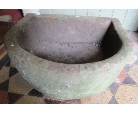 A natural stone D shaped trough 56 cm wide x 47 cm deep x 20 cm in height approx