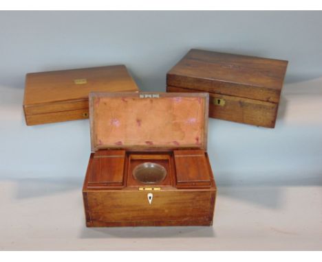 Cross banded mahogany tea caddy, the hinged lid enclosing an interior with two lidded compartments and glass mixing bowl, 31c