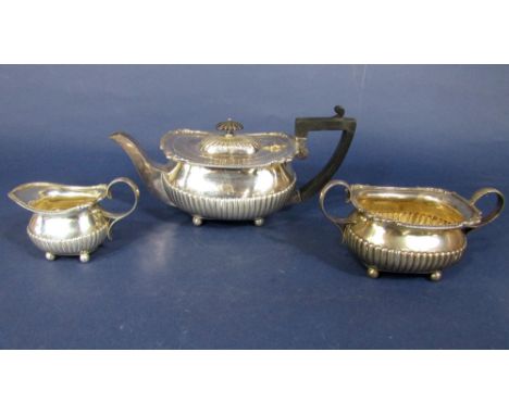 Early 20th century Georgian style boat shaped half fluted tea service comprising teapot, milk jug and sucrier, London 1910, t