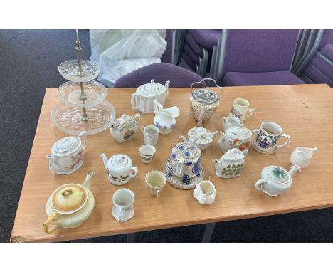 Selection of vintage teapots, cups and cake stand