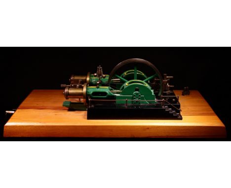 A well-engineered live steam horizontal stationary steam mill engine, central 6.5" diameter six spoke flywheel painted green,