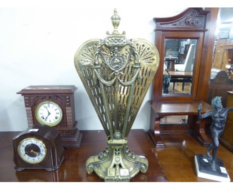 A VICTORIAN PIERCED BRASS FIRE-SCREEN, THE FAN FOLDING AWAY TO THE CENTRAL COLUMN, WITH CLASSICAL SWAGS, EIGHT PART FAN 