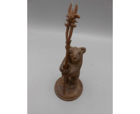 Black Forest Style Bear holding carved stick bear is 5 inches tall