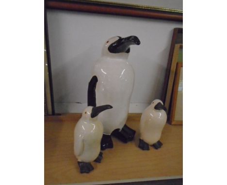 set of ceramic penguins,  tallest is 18" tall and the two babies are 10" tall