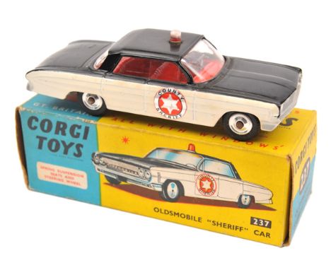 Corgi Toys Oldsmobile “Sheriff” Car (237). In gloss black and white with red interior, light to roof, County Sheriff labels t