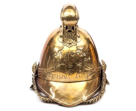 A fireman’s brass helmet c 1910 of the London Fire Brigade, with binding to front peak and extended back peak, ear to ear hel