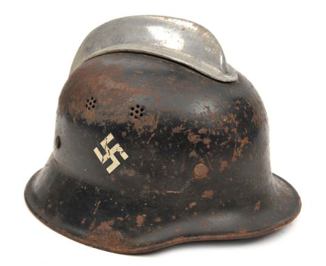 A Third Reich Fireman’s steel helmet, with aluminium comb and 2 pairs of 7 hole vents on each side, the black finish with Civ