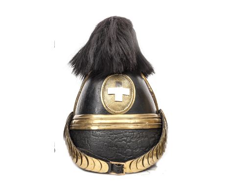 A Swiss dragoon leather helmet, c 1852, brass mounts including binding to front peak, panelled headband, plain leather backed